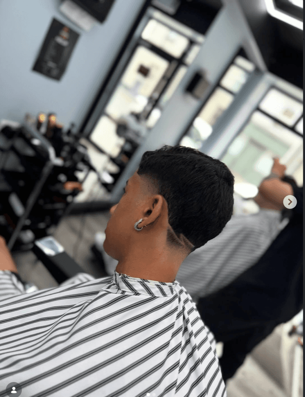 Precision shave — barber at work with straight razor